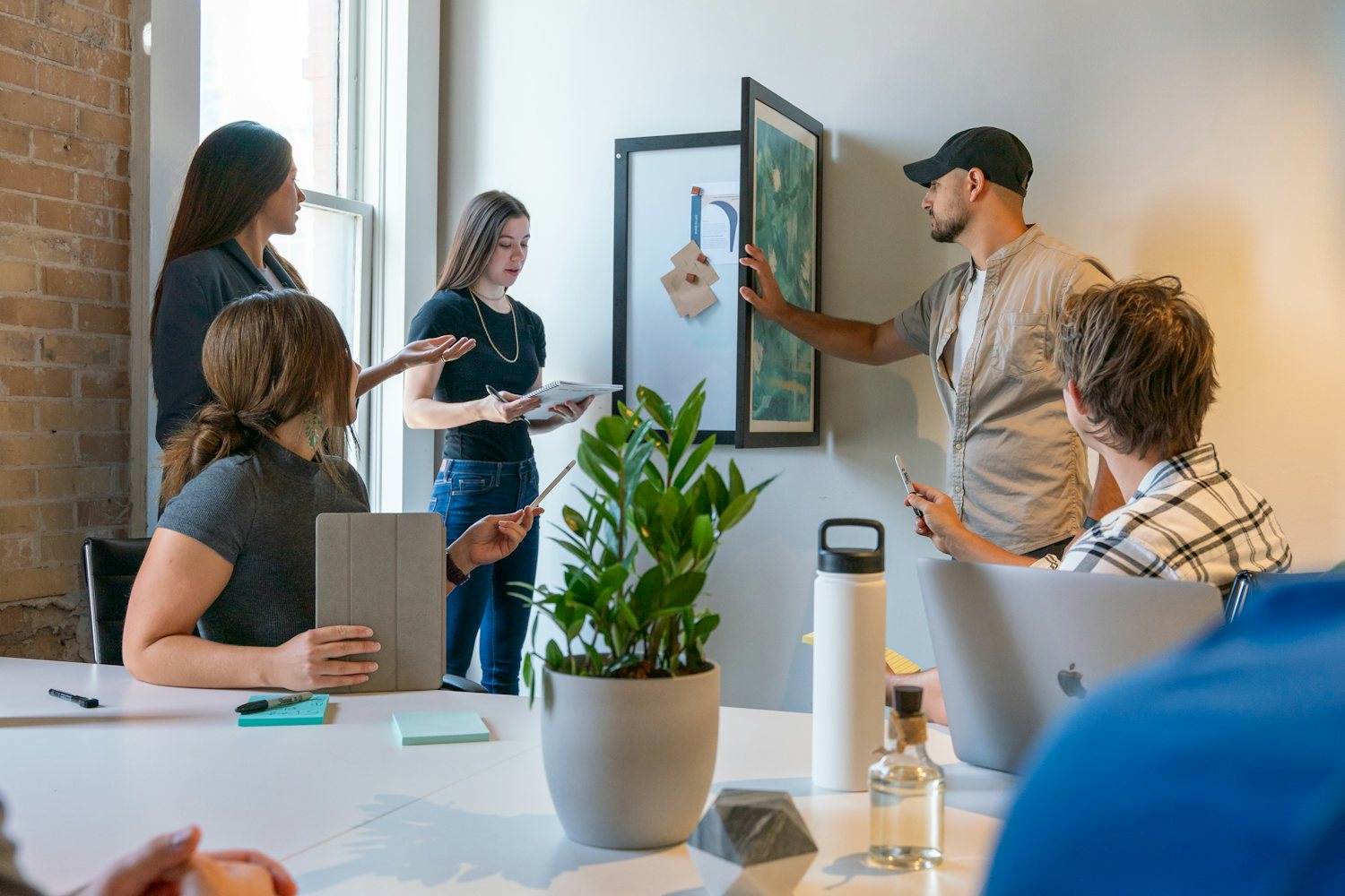 Project team reviewing plans together in a meeting