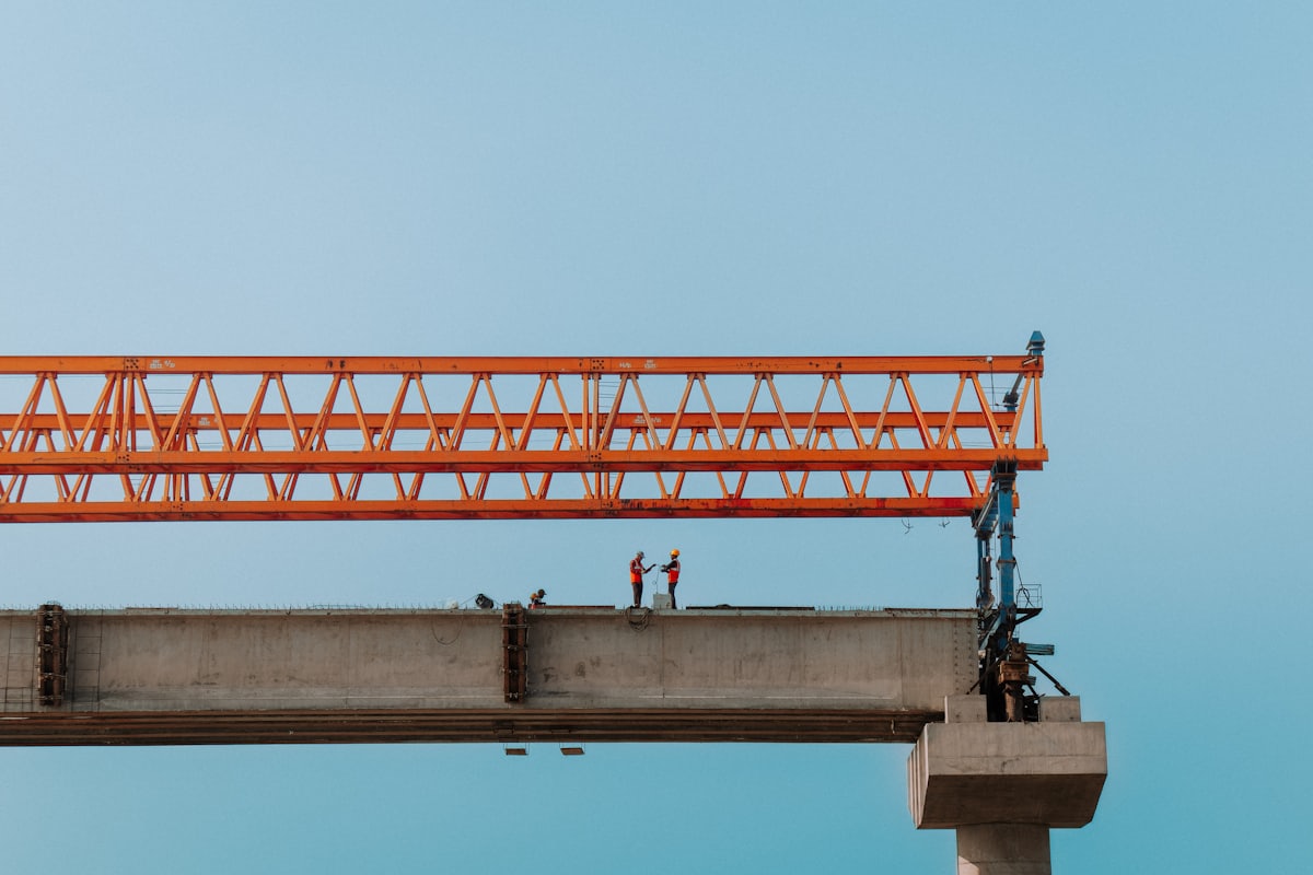Site personnel in high-visibility gear coordinating work on a structure